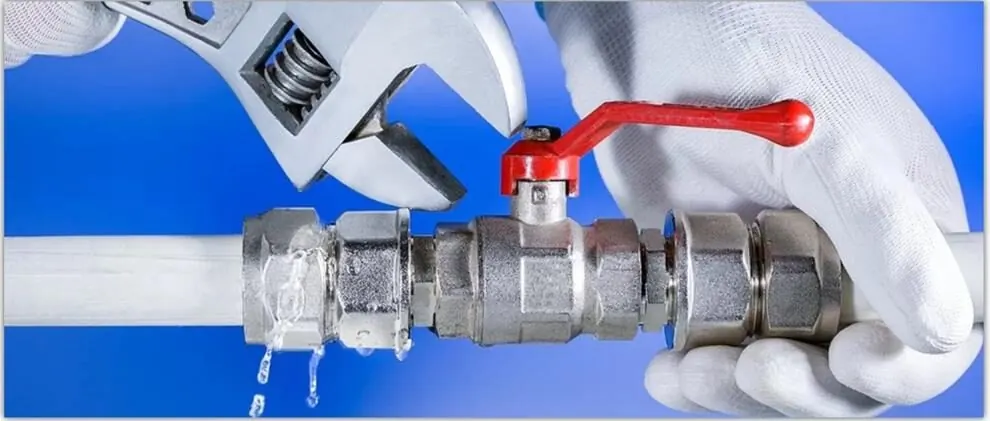 Technician fitting a red-handled valve